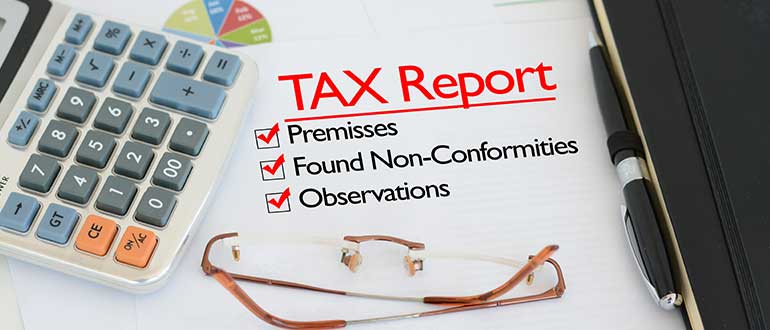Tax report on a desk with tick against premises
